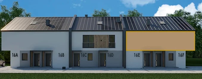 Modern townhouses with white and tan facades, dark metal roofs, and numbered unit doors facing a street